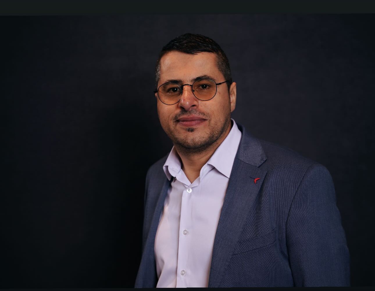 Man in a suit wearing glasses 
