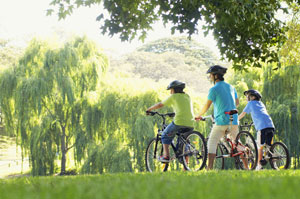man and two children on bikes