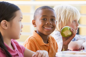 smiling boy holding apple